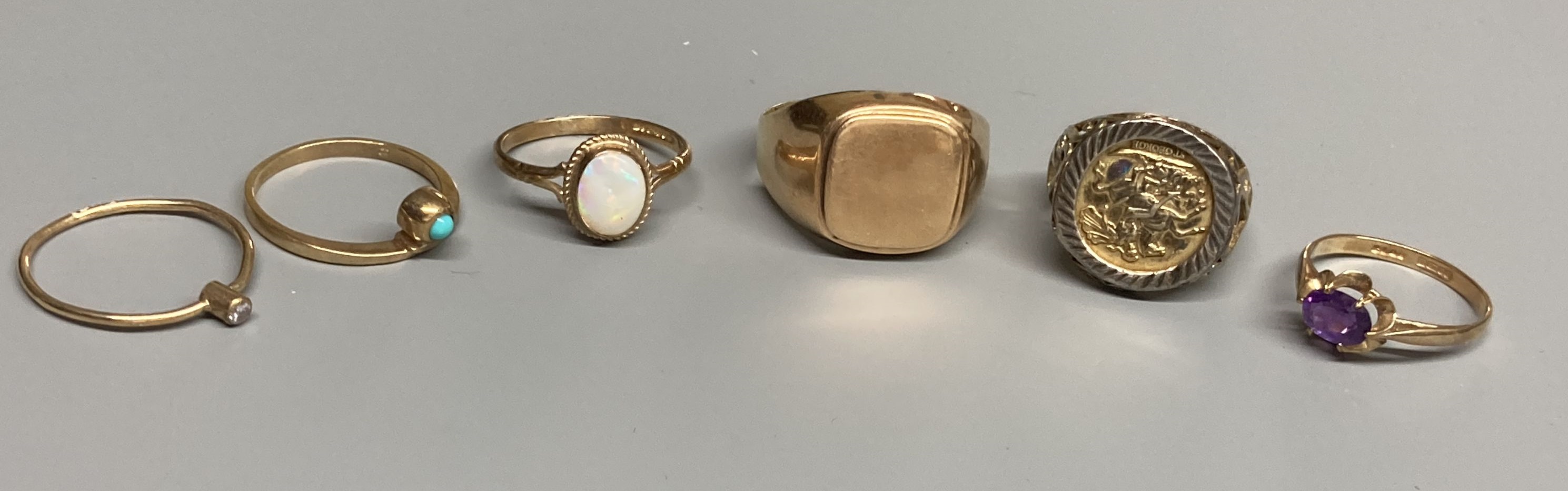 Four assorted modern 9ct gold and gem set rings, a 9ct gold signet ring(cut) and a white metal ring